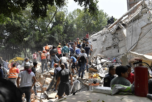 people remove debris of a collapsed building to look for possible victims after a quake rattled mexico city photo afp
