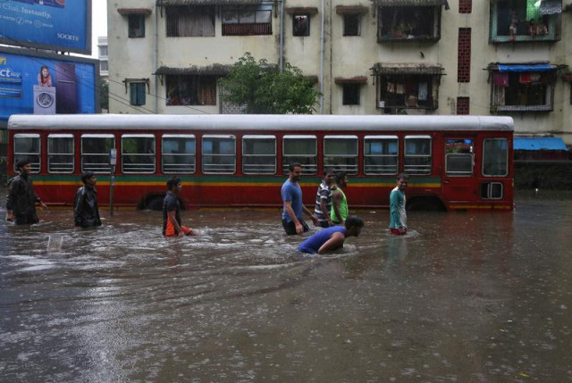 people wade through a water logged road past a stalled passenger bus during rains in mumbai august 29 2017 photo reuters people wade through a water logged road past a stalled passenger bus during rains in mumbai august 29 2017 photo reuters
