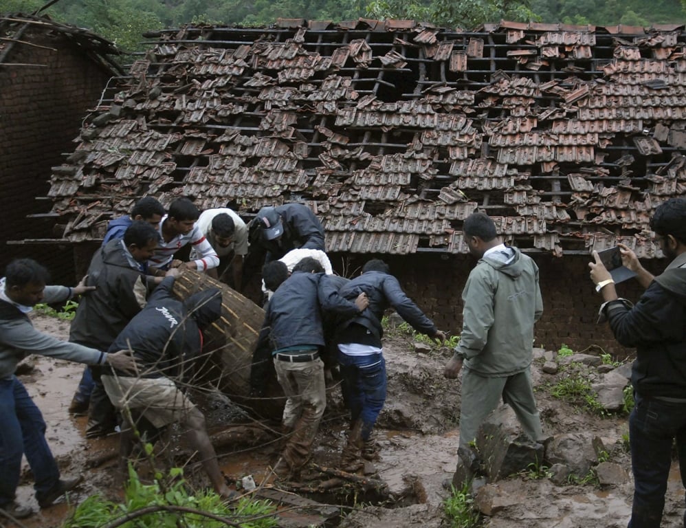 rescue workers and volunteers clear the debris from the site of a landslide at malin village in the western indian state of maharashtra photo reuters