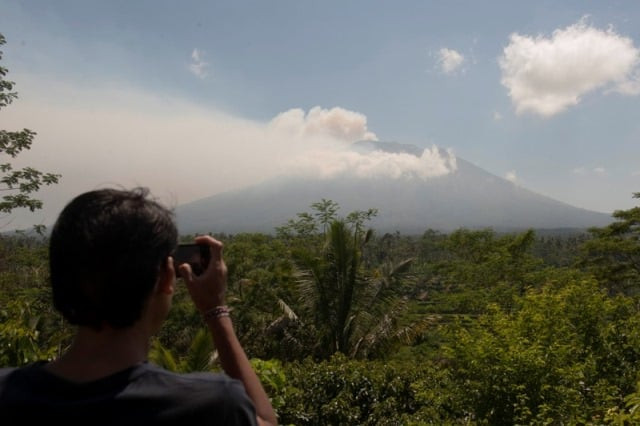 a local resident takes a picture of mount agung an active volcano that authorities say is showing increased activity from a monitoring station in rendang village karangasem on the resort island of bali indonesia september 19 2017 photo reuters a local resident takes a picture of mount agung an active volcano that authorities say is showing increased activity from a monitoring station in rendang village karangasem on the resort island of bali indonesia september 19 2017 photo reuters