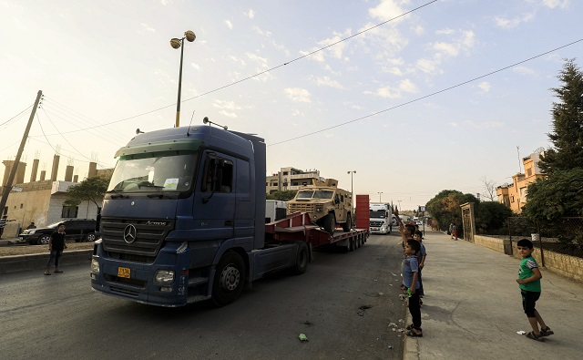 a military convoy composed of 140 trailers carrying us made armoured vehicles bulldozers and arms through simalka border crossing between syria and iraqi kurdistan and headed for sdf forces fighting in raqa in the northeastern syrian city of qamishli on september 19 2017 photo afp