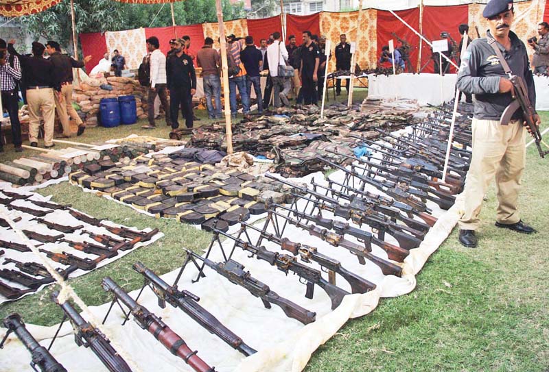 a huge cache of arms and ammunition was recovered from a customised water tank of a house in azizabad law enforcers termed it sindh s biggest bust of arms in history photo file