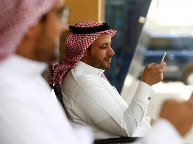 saudi men explore social media on their mobile devices as they sit at a cafe in riyadh photo reuters file