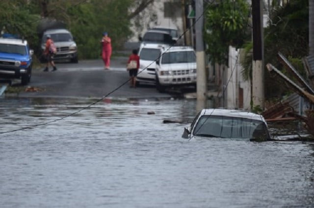 a car is viewed stuck in a flooded street in santurce in san juan puerto rico on september 21 2017 puerto rico braced for potentially calamitous flash flooding on thursday after being pummeled by hurricane maria which devastated the island and knocked out the entire electricity grid the hurricane which puerto rico governor ricardo rossello called quot the most devastating storm in a century quot had battered the island of 3 4 million people after roaring ashore early wednesday with deadly winds and heavy rain photo afp a car is viewed stuck in a flooded street in santurce in san juan puerto rico on september 21 2017 puerto rico braced for potentially calamitous flash flooding on thursday after being pummeled by hurricane maria which devastated the island and knocked out the entire electricity grid the hurricane which puerto rico governor ricardo rossello called quot the most devastating storm in a century quot had battered the island of 3 4 million people after roaring ashore early wednesday with deadly winds and heavy rain photo afp