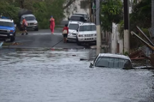 a car is viewed stuck in a flooded street in santurce in san juan puerto rico on september 21 2017 puerto rico braced for potentially calamitous flash flooding on thursday after being pummeled by hurricane maria which devastated the island and knocked out the entire electricity grid the hurricane which puerto rico governor ricardo rossello called quot the most devastating storm in a century quot had battered the island of 3 4 million people after roaring ashore early wednesday with deadly winds and heavy rain photo afp a car is viewed stuck in a flooded street in santurce in san juan puerto rico on september 21 2017 puerto rico braced for potentially calamitous flash flooding on thursday after being pummeled by hurricane maria which devastated the island and knocked out the entire electricity grid the hurricane which puerto rico governor ricardo rossello called quot the most devastating storm in a century quot had battered the island of 3 4 million people after roaring ashore early wednesday with deadly winds and heavy rain photo afp