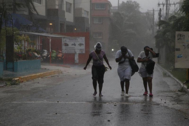 women walk against the wind before the arrival of hurricane maria in punta cana dominican republic photo reuters women walk against the wind before the arrival of hurricane maria in punta cana dominican republic photo reuters