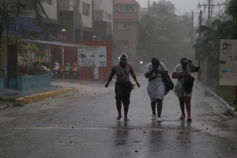 women walk against the wind before the arrival of hurricane maria in punta cana dominican republic photo reuters