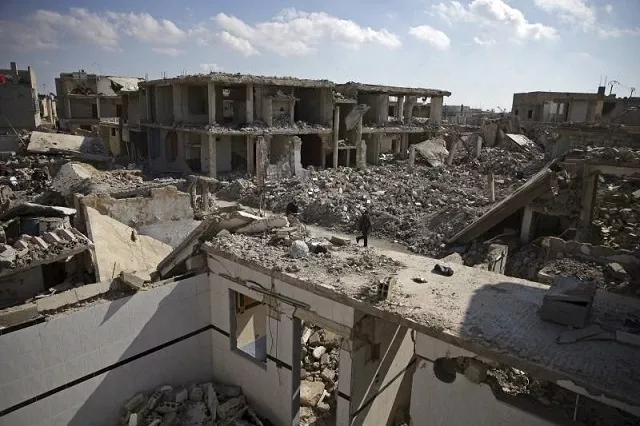 people walk past damaged buildings in the douma neighborhood of damascus syria february 9 2016 photo reuters bassam khabieh people walk past damaged buildings in the douma neighborhood of damascus syria february 9 2016 photo reuters bassam khabieh