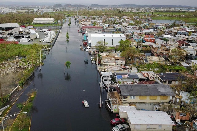 an aerial view shows the flooded neighbourhood of juana matos in the aftermath of hurricane maria in catano puerto rico on september 22 2017 puerto rico battled dangerous floods friday after hurricane maria ravaged the island as rescuers raced against time to reach residents trapped in their homes and the death toll climbed to 33 puerto rico governor ricardo rossello called maria the most devastating storm in a century after it destroyed the us territory 039 s electricity and telecommunications infrastructure photo afp