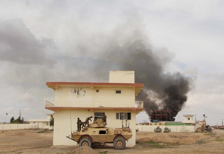 smoke billows from a building after a taliban attack in gereshk district of helmand province afghanistan photo reuters