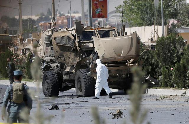 an afghan official investigates a damaged danish convoy at the site of a car bomb attack in kabul afghanistan september 24 2017 photo reuters