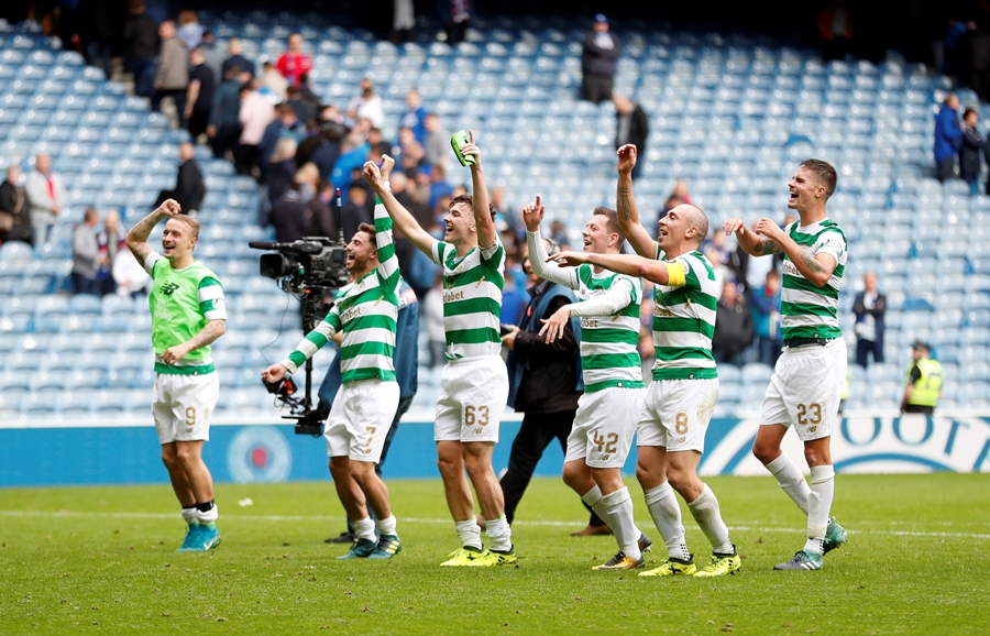 celtic players celebrate in front of the fans after the match against rangers photo reuters