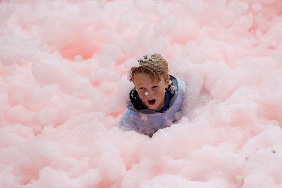 a boy falls during a charity bubble run in leicester britain photo reuters