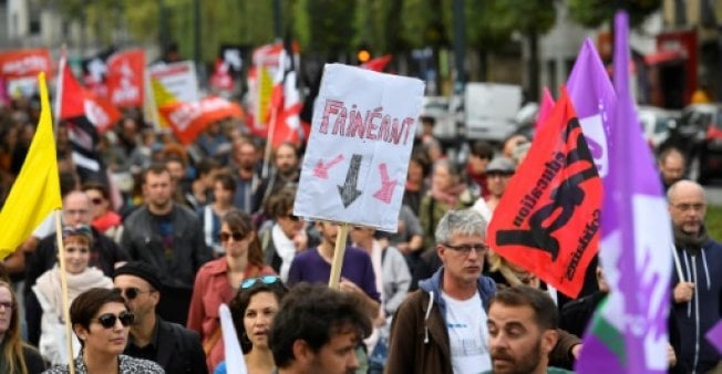 a demonstrator holds a sign reading quot slacker quot during a protest called by several french unions against proposed labour law reforms president emmanuel macron has described critics of the plan as quot slackers photo afp