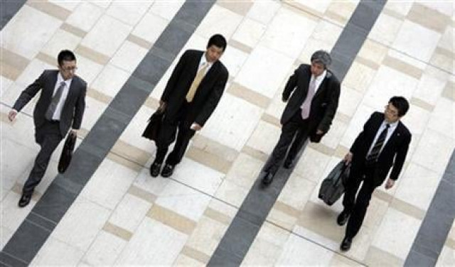 businessmen walk on a street photo reuters businessmen walk on a street photo reuters