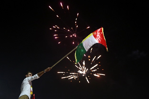 iraqi kurds wave the kurdish flag as they celebrate in the streets of the northern city of arbil photo afp