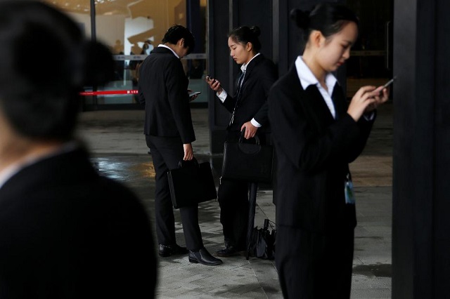 people check their phones during the third annual world internet conference in wuzhen town of jiaxing zhejiang province china november 17 2016 photo reuters