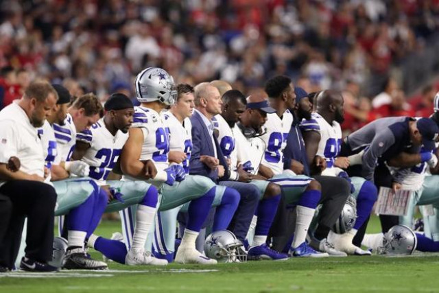 members of the dallas cowboys link arms before the national anthem at the start of the nfl game against the arizona cardinals in glendale photo afp members of the dallas cowboys link arms before the national anthem at the start of the nfl game against the arizona cardinals in glendale photo afp