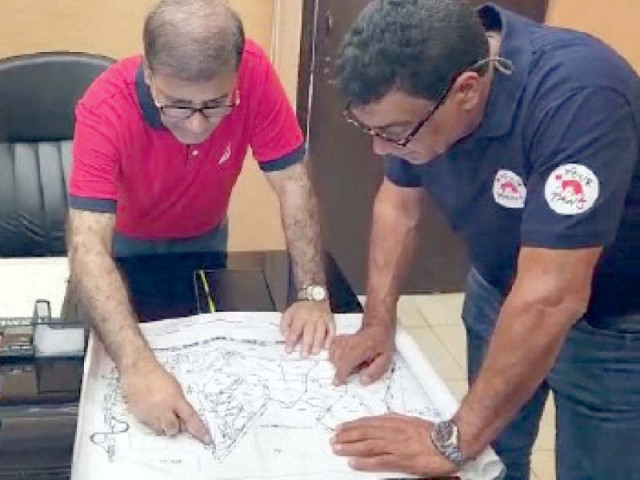 a karachi zoo official explains to a four paws team member on a map about the safari park photo express a karachi zoo official explains to a four paws team member on a map about the safari park photo express