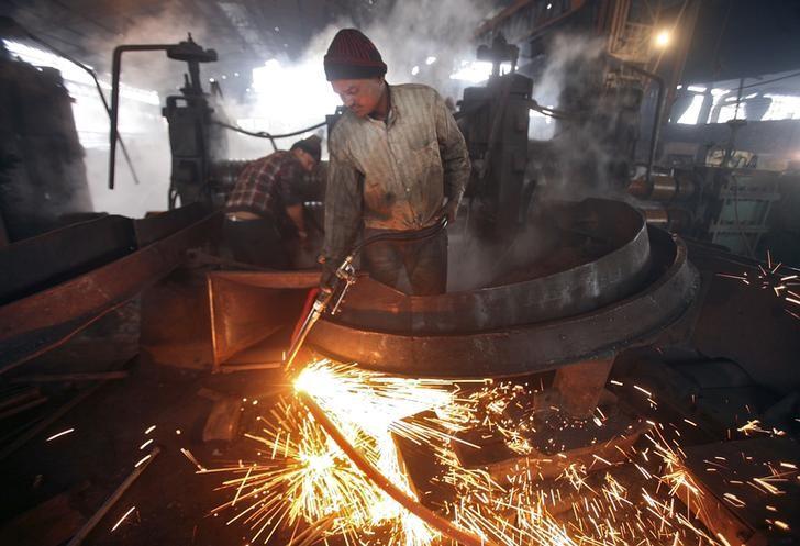 a worker cuts a steel rod inside a steel factory photo reuters