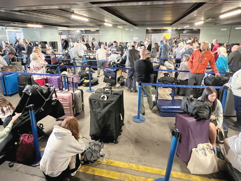 passengers queue outside terminal 1 after an overnight power cut led to disruptions and cancellations at manchester airport in manchester photo reuters