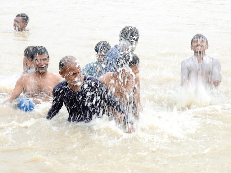 men enjoy in mori canal in hyderabad on an extremely hot day on sunday photo express