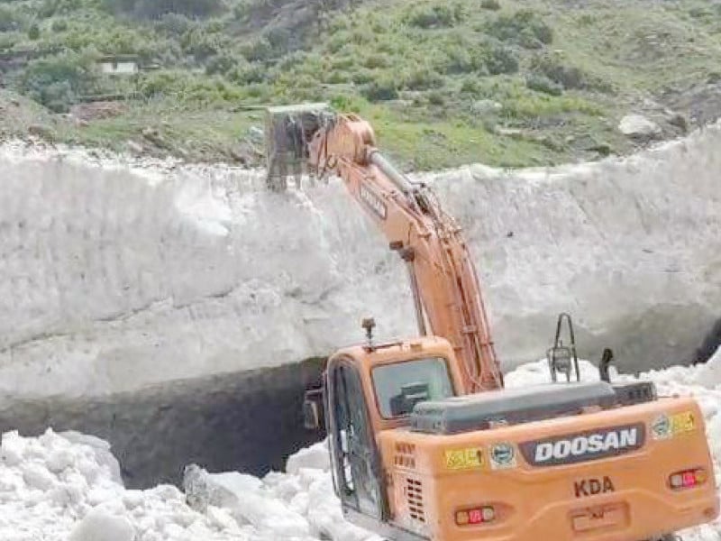kaghan development authority kda employees demolish a melting glacier with the help of machinery in naran to clear the road photo express