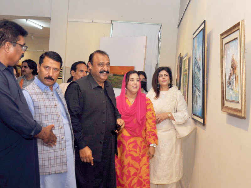 visitors explore the paintings at an exhibition held at the punjab arts council on wednesday photo express