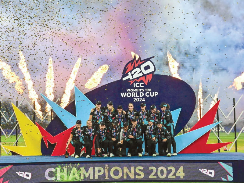 new zealand players celebrate with their trophy after winning the icc women s t20 world cup at dubai cricket stadium on sunday night photo afp