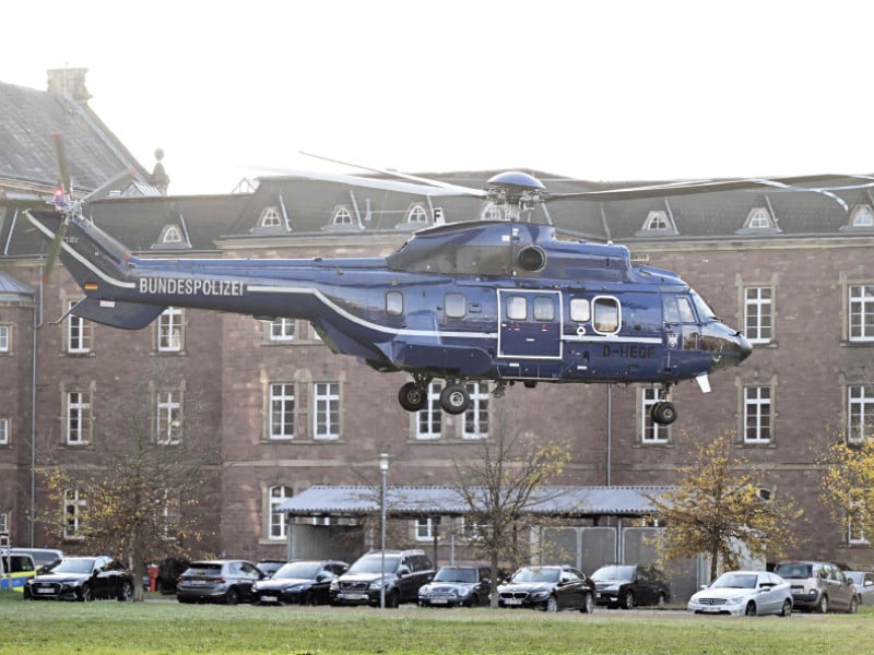 a helicopter carrying two of eight suspected members of a militant group takes off from the courtyard of the federal court of justice in karlsruhe southern germany photo afp