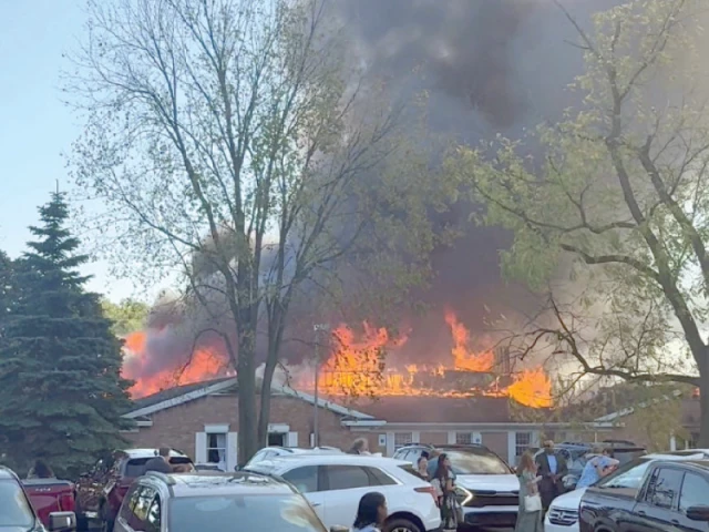 people gather at the site as smoke and fire rise in grand blanc photo reuters