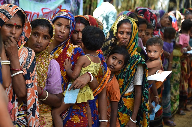 this september 26 2017 photo shows hindu women refugees from myanmar waiting in line for a food distriuition at the kutupalong hindu village near ukhia hindu eyewitnesses told afp the bloodshed before they fled for bangladesh occurred outside their small hindu village in kha maung seik in northern rakhine state where myanmar authorities have exhumed 45 hindu corpses from mass graves since september 24 photo afp