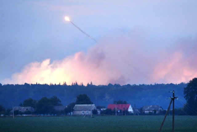 police said the flames caused artillery shells at the facility to explode one after the other photo afp