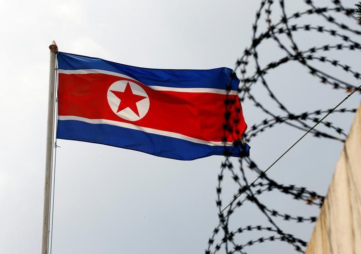 a north korean flag flutters next to concertina wire at the north korean embassy in kuala lumpur malaysia photo reuters