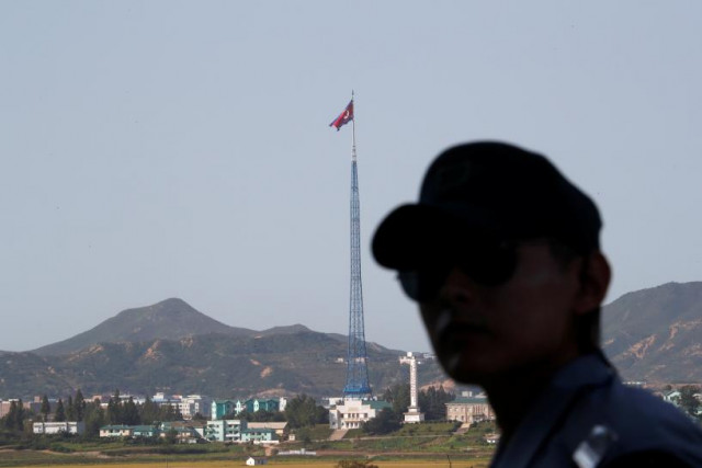 a south korean soldier stands guard as a north korean flag flutters on top of a tower at the propaganda village of gijungdong in north korea in this picture taken near the truce village of panmunjom south korea september 28 2017 photo reuters a south korean soldier stands guard as a north korean flag flutters on top of a tower at the propaganda village of gijungdong in north korea in this picture taken near the truce village of panmunjom south korea september 28 2017 photo reuters
