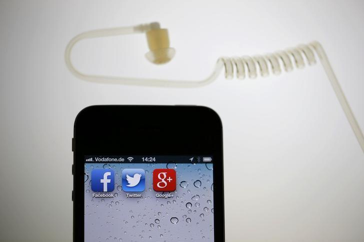 the application icons of facebook twitter and google are displayed on an iphone next to an earphone set in this illustration photo taken in berlin june 17 2013 photo reuters