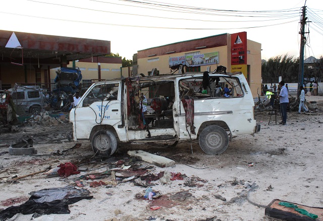 bystanders look at the wreckage of a minibus after a car bomb exploded in the centre of mogadishu on september 28 2017 at least seven people were killed and several others wounded after a car bomb exploded near a marketplace in somalia 039 s capital mogadishu a city official said the blast occurred alongside a densely populated road near hamarweyne market an area where bombings claimed by the islamist shabaab insurgency have previously occurred photo afp