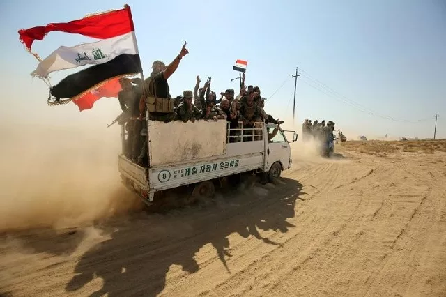 iraqi paramilitaries of the popular mobilisation force flash the victory sign as they advance on the islamic state group held enclave around the northern town of hawija on september 22 2017 photo afp iraqi paramilitaries of the popular mobilisation force flash the victory sign as they advance on the islamic state group held enclave around the northern town of hawija on september 22 2017 photo afp