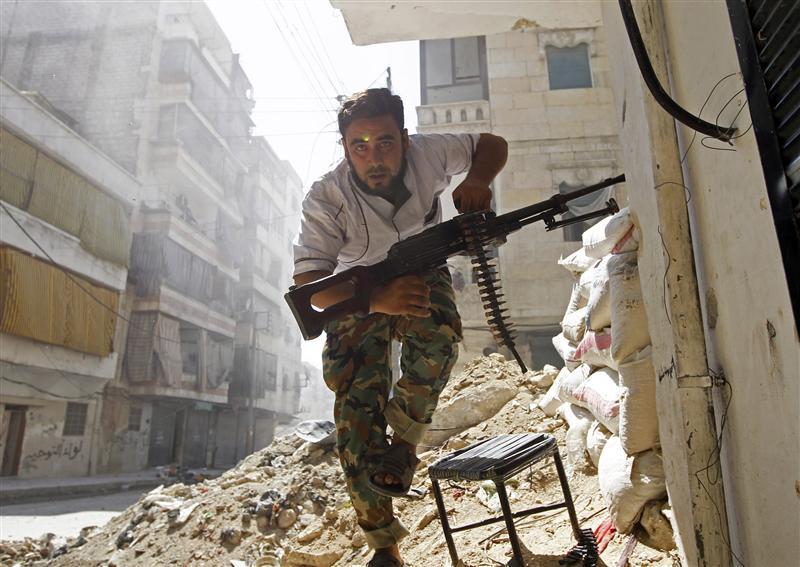 a free syrian army fighter takes cover during clashes with syrian army in the salaheddine neighbourhood of central aleppo photo reuters