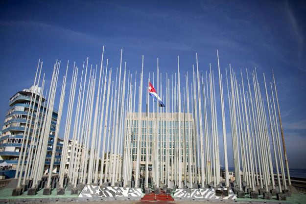 a cuban flag flies in front of the us interests section background in havana photo reuters