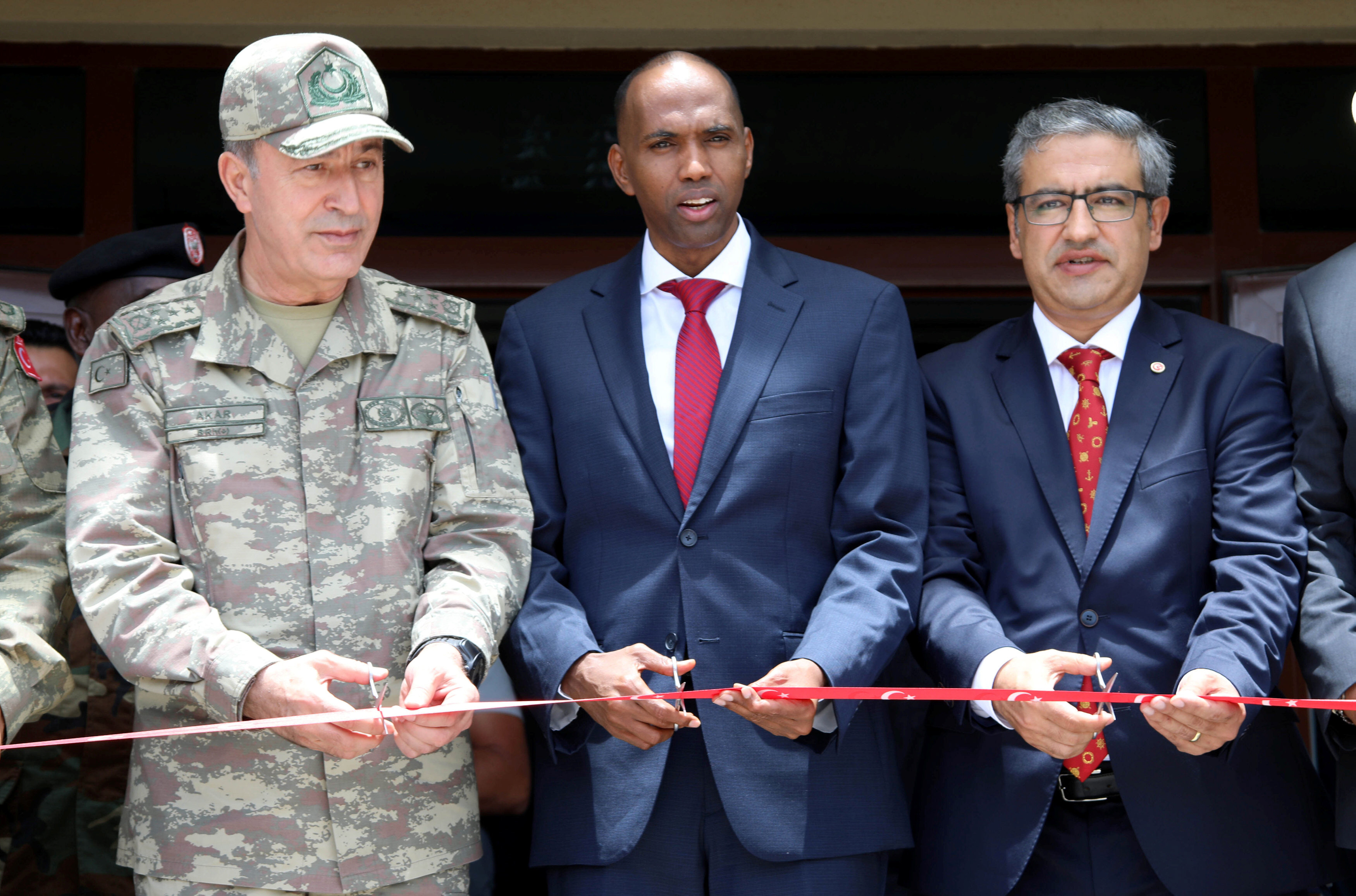 somali prime minister hassan ali khaire c and a turkish military official cut the ribbon at the opening ceremony of the turkish military base in somalia photo reuters