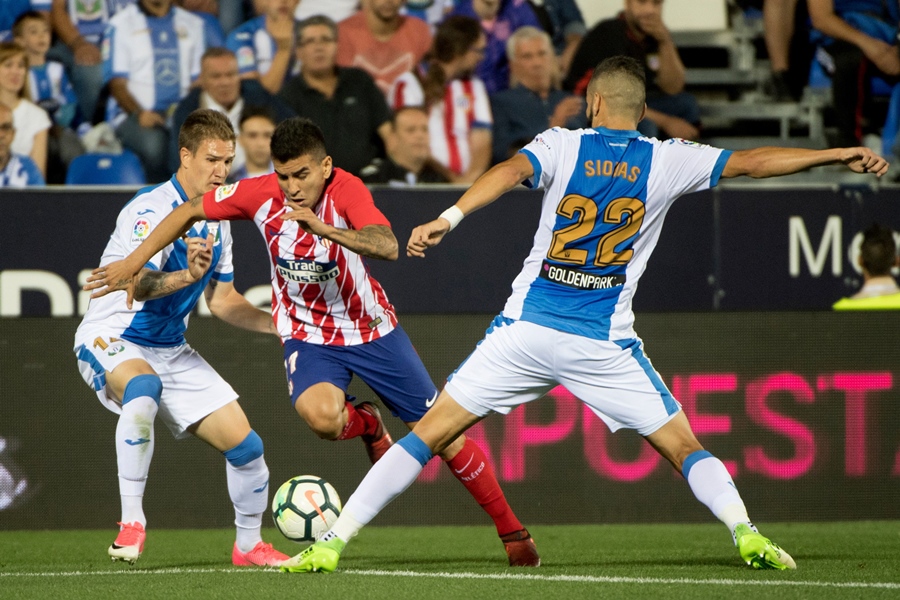 leganes 039 defender from spain raul garcia carnero l and leganes 039 defender from greece joseba zaldua bengoetxea r vie with atletico madrid 039 s forward from argentina angel correa during the spanish league football match club deportivo leganes sad vs club atletico de madrid at the estadio municipal butarque in madrid on september 30 2017 photo afp