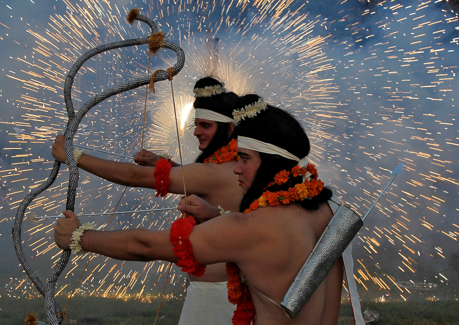 artists dressed as hindu gods rama and laxman act as fireworks explode during vijaya dashmi or dussehra festival celebrations in chandigarh india photo reuters