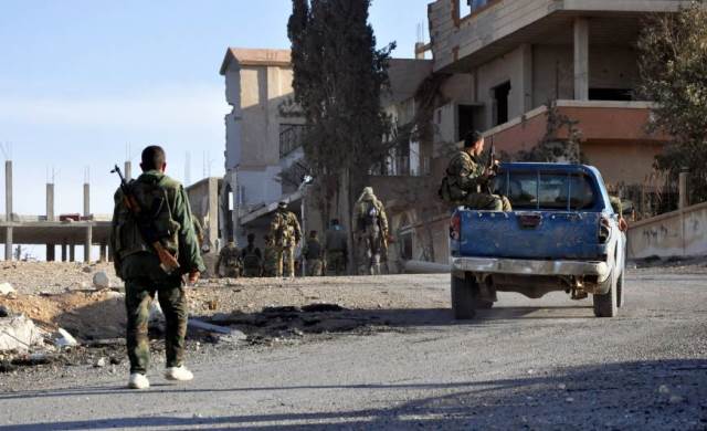 syrian soldiers patrol the town of al quaryatayn in syria 039 s central homs province sunday photo afp