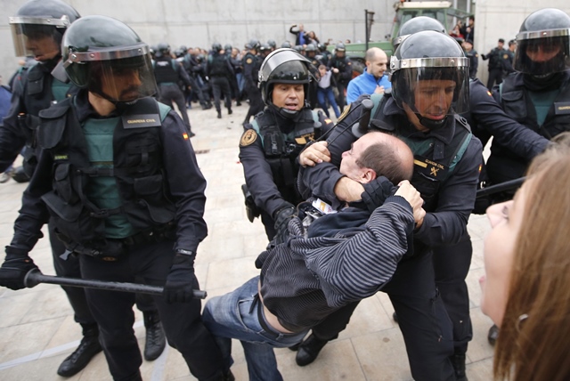 spanish guardia civil guards drag a man outside a polling station in sant julia de ramis where catalan president was supposed to vote on october 1 photo afp