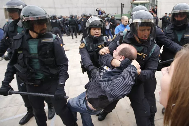 spanish guardia civil guards drag a man outside a polling station in sant julia de ramis where catalan president was supposed to vote on october 1 photo afp spanish guardia civil guards drag a man outside a polling station in sant julia de ramis where catalan president was supposed to vote on october 1 photo afp