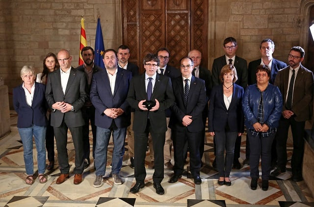 catalan regional president carles puigdemont c is flanked by members of his government as he makes an statement at generalitat palace in barcelona spain october 1 2017 photo reuters