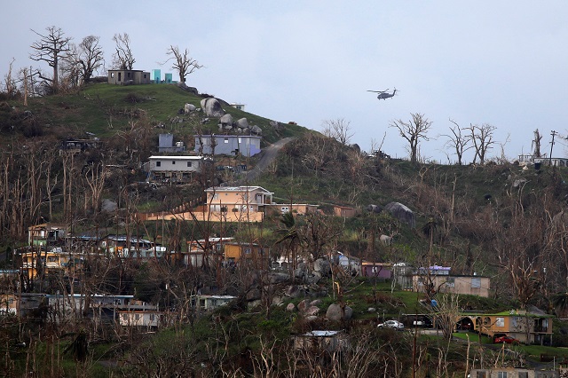 a military helicopter flight over a residential area following damages caused by hurricane maria near caguas puerto rico october 1 2017 photo reuters