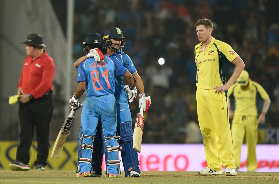 indian cricketer manish pandey c and kedar jadhav celebrate as australian cricketer james faulkner r watches after india won the fifth one day international cricket match against india at the vidarbha cricket association stadium in nagpur on october 1 2017 photo afp