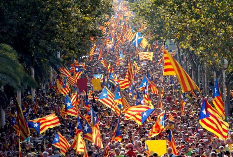 people hold catalan separatist flags known as quot esteladas quot during a gathering to mark the calatalonia day quot diada quot in central barcelona spain photo reuters